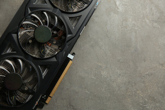 One graphics card on grey table, top view. Space for text