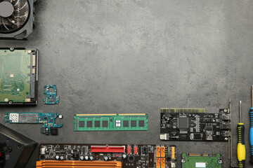 Poster - Graphics card and other computer hardware on grey textured table, flat lay. Space for text