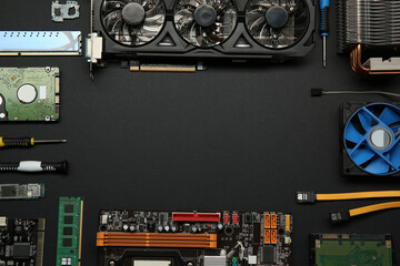 Poster - Frame of graphics card and other computer hardware on black background, flat lay. Space for text