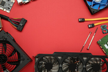 Poster - Graphics card and other computer hardware on red background, flat lay. Space for text