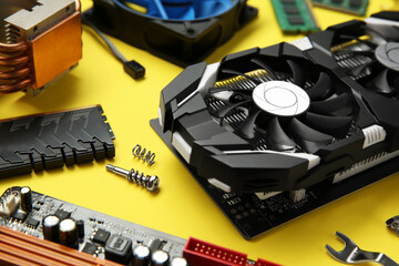 Poster - Graphics card and other computer hardware on yellow background, closeup