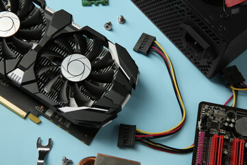 Poster - Graphics card and other computer hardware on light blue background, above view