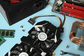 Poster - Graphics card and other computer hardware on light blue background, closeup