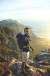 © peopleimages.com - Portrait, mountains and hiking with man, view and journey with nature, environment and getaway trip. Ocean, person and hiker with backpack, adventure and fitness with happiness, holiday and wellness