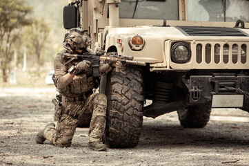 Wall Mural - United States Army in camouflage uniforms operation in the forest.with armored vehicle, soldiers training  in a military operation