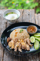 Wall Mural - Steamed rice and chicken, served with soup and various sauce.