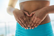© peopleimages.com - Woman, stomach and hands for heart in outdoor, gut health and digestion or support for belly. Female person, emoji and weight loss or love results of detox, self care and abdomen or colon wellness