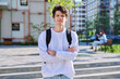 © Valerii Honcharuk - Portrait of college student guy looking at camera outdoor near educational building