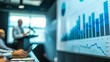 © Rattanathip - Business meeting with presentation on financial data analysis, focusing on charts and graphs, in a modern conference room.