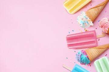 Poster - Assorted colorful pastel summer ice cream cones and popsicle frozen desserts. Top down view side border on a pink background. Copy space.