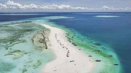 Wall Mural - Aerial view of Nakupenda island, sandbank in ocean, white sand, boats, yachts, blue sea during low tide at sunny summer day in Zanzibar. Top drone view of sand spit, clear water, sky, clouds. Tropical