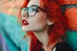 © VISUAL BACKGROUND - A woman with red hair and glasses leaning against a wall.