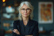 © KADER - Elegant Middle-Aged Businesswoman with Glasses in Modern Office