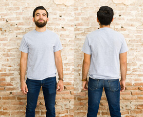 Wall Mural - Smiling young hispanic man in a plain grey t-shirt for mock-up designs, shown from both front and back against a brick wall