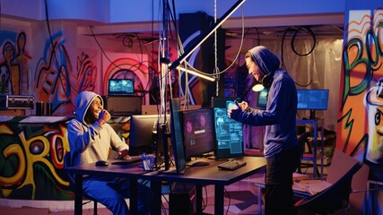 Poster - hackers in abandoned warehouse celebrating after successfully using phishing technique that tricks u