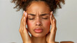 © Klay - young woman in distress holding her head, expressing headache or stress