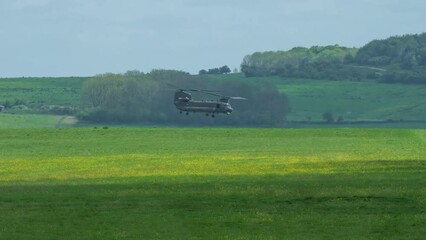 Wall Mural - RAF Chinook tandem-rotor helicopter practising landing and hover, Wilts UK