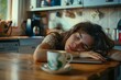 © Azhorov - A woman laying her head on a table next to a cup of coffee