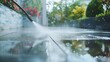 © atipong - Patio cleaning using high-pressure jet: A detailed view of terrace cleaning.