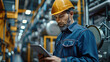 © wasan - Factory worker using wireless technology to monitor and control machinery
