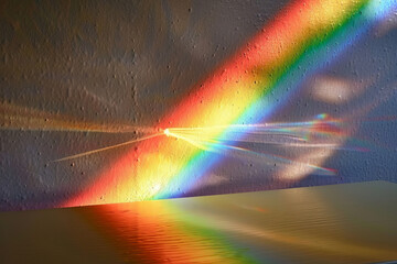 Wall Mural - A rainbow is reflected in a window, creating a beautiful and colorful scene