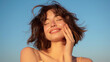© Who is Danny - Smiling woman enjoying the breeze, clear blue sky background, concept of happiness and relaxation. Generative AI