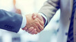 © Who is Danny - Two people in business attire shaking hands, blurred office background, concept of agreement. Generative AI