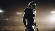 © abu - Silhouette of a professional football player. The background is dark and the warm spotlights is on
