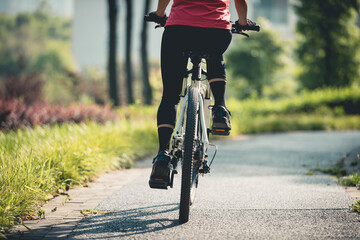 Wall Mural - Woman riding mountain biking in sunny park