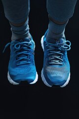 Poster - Close-up view of a person's feet in blue sneakers. Suitable for various lifestyle and fashion concepts