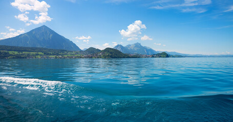 Wall Mural - panorama landscape lake Thunersee, from boat trip, blue sky with clouds. switzerland