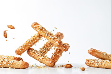 Poster - Sesame Seed Breadsticks Falling On White Background
