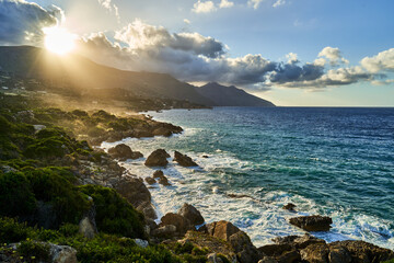 sunlight illuminates water from rocky shores overlook