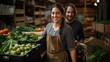 © ORG - Fruit and vegetable shop owner, happy woman holding vegetables near crates in a stall at the market