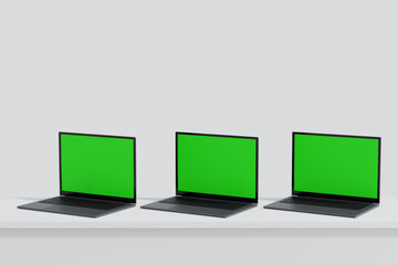 Wall Mural - three laptop open to show green screen display on white background, application website present, 3d 