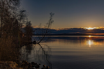 Wall Mural - Sunset over Lake Vasman in Ludvika County, Sweden and the colorful sky with clouds