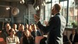 © Felippe Lopes - Confident CEO delivering a motivational speech to a diverse group of employees in a modern office environment.