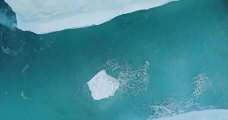 Wall Mural - Huge high ice glacier at polar nature environment. Antarctica melting blue water iceberg. Ecology, melting ice, climate change and global warming concept. Arctic background. Aerial drone shot