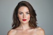 © Adam - Beautiful woman with brown hair, blue eyes, skin with light freckles, and red lips, isolated background, studio shot
