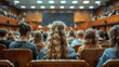 © familymedia - Rows of students attentively listen to a speaker outside of the frame in a large wood-paneled lecture hall