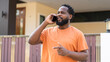 © Art_Photo - African cheerful man enjoys a lively conversation on his mobile phone, modern communication, the joy of connection, and the simplicity of daily life,technology in everyday life