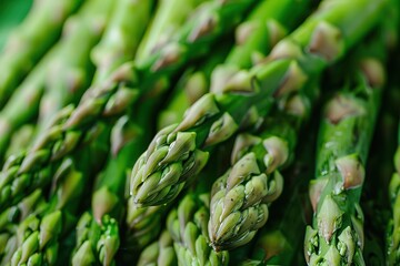 Wall Mural - Pile of fresh young asparagus in the photo on a black background