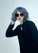 © Angelina Zhuravleva  - a beautiful woman with purple hair wearing round sunglasses on a blue background