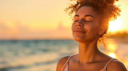 Wall Mural - Woman enjoying a peaceful moment as the sun sets over the sea