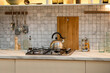 © Sergey - A stainless steel kettle sits on a gas stove in the kitchen