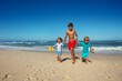 © Sergey Novikov - Barefoot race by the coastal waters of three happy siblings