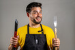 © Javier - Cocinero contento y feliz sosteniendo sus utensillos de cocina