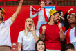 © Mediteraneo - Sport fans are cheering for their team at the stadium on the match in red colors.