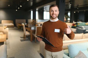 Wall Mural - Confident salesman standing in furniture store exhibition center