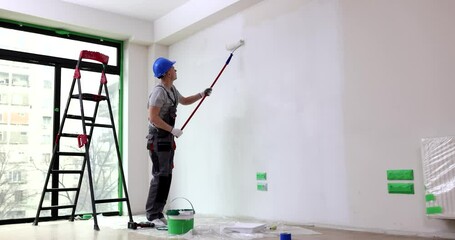 Wall Mural - Painting walls with white paint roller. Painting bare wall with roller with white paint